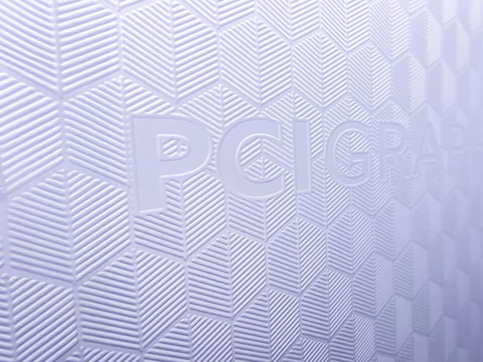 Close up of a textural print with a graphic design and the words "PCI Graphics"