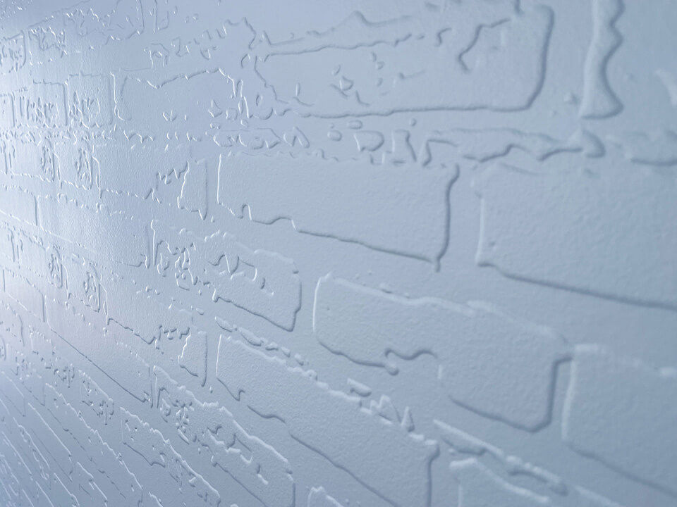 Textural print simulating white-painted bricks.