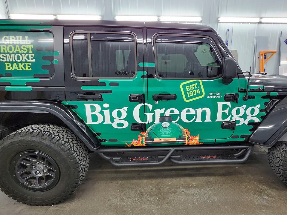 Side view of jeep with "Big Green Egg" full-color vehicle wrap.
