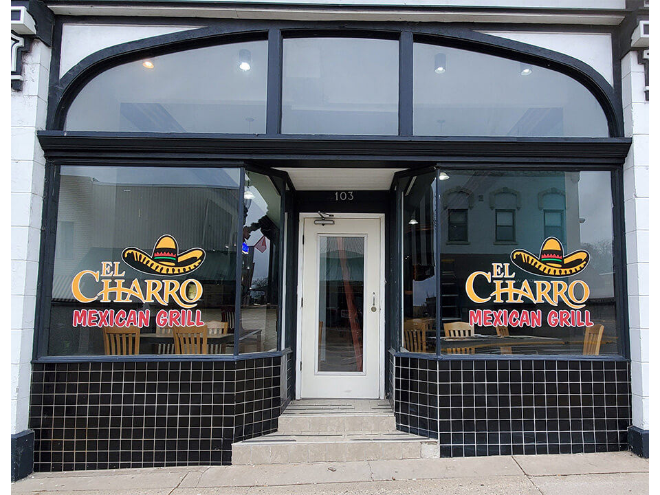 Front view of restaurant entrance with window graphics.