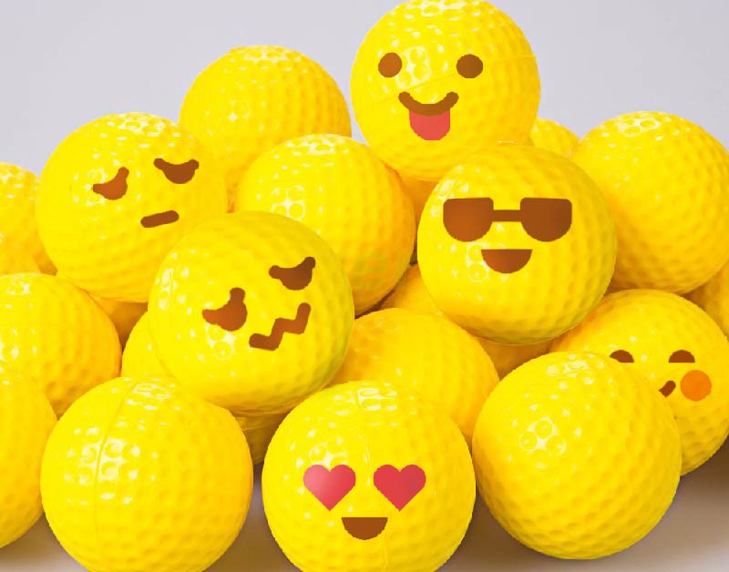 Yellow emoji golf balls