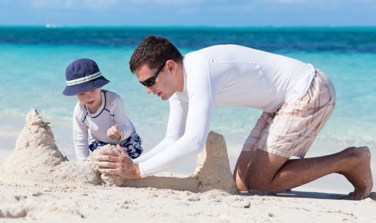 Designer_at_beach_with_child