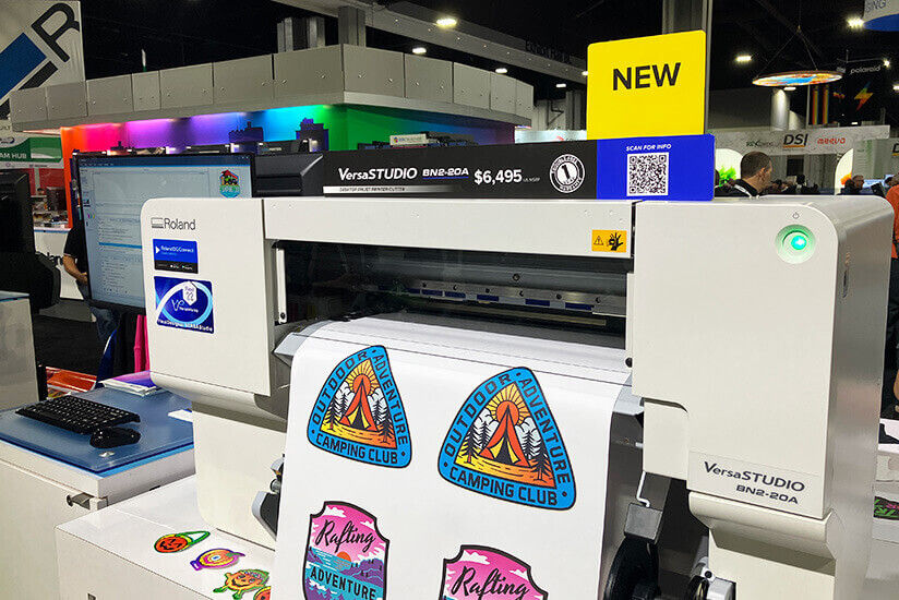 Roland DG printer with printed media emerging.