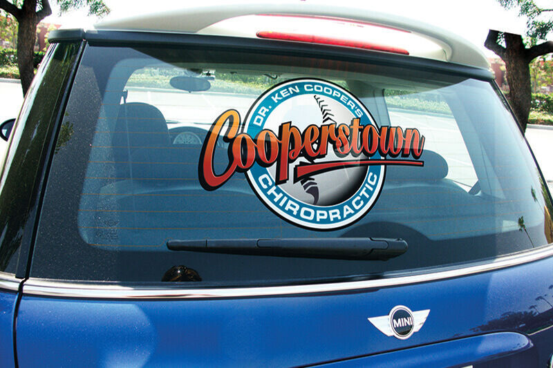 Rear window of a blue Mini Cooper with window graphics for Cooperstown