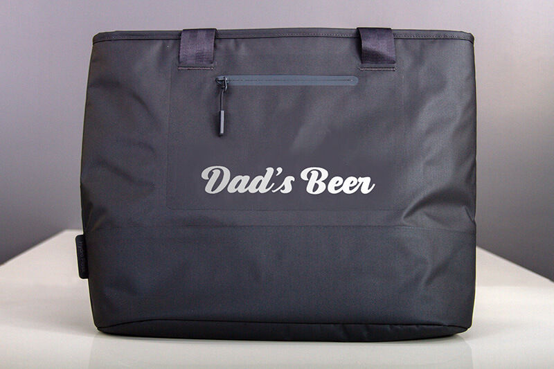 Black soft-sided cooler with the words "Dad's Beer" custom printed on the side