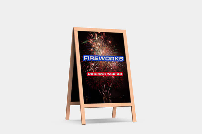 Sandwich board sign directing traffic for fireworks with fireworks graphic