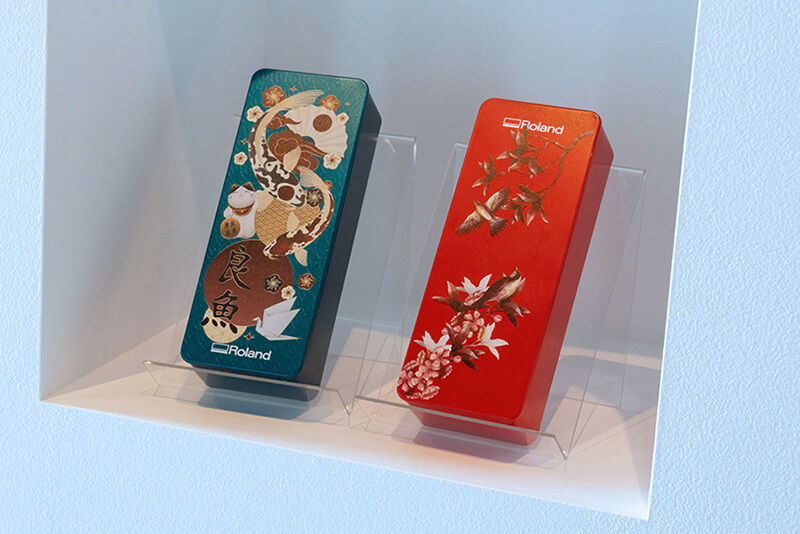 A display of two custom-printed rectangular boxes at the Roland DG headquarters exhibition space