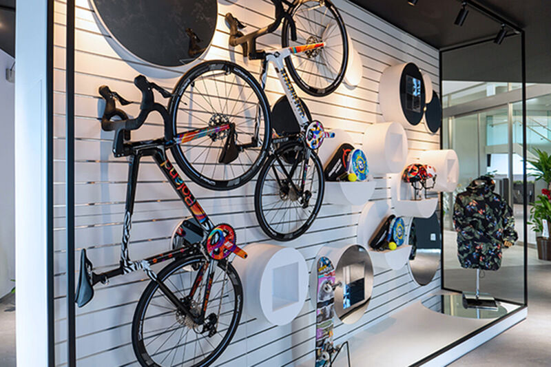 A display of custom-printed sporting good equipment including bicycles and helmets.