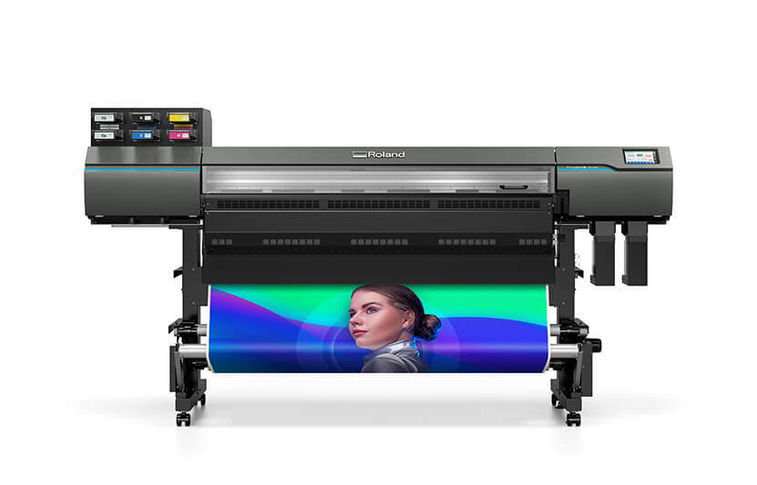 Roland DG's AP-640 wide-format latex printer printing a graphic of a woman on a purple and green background.