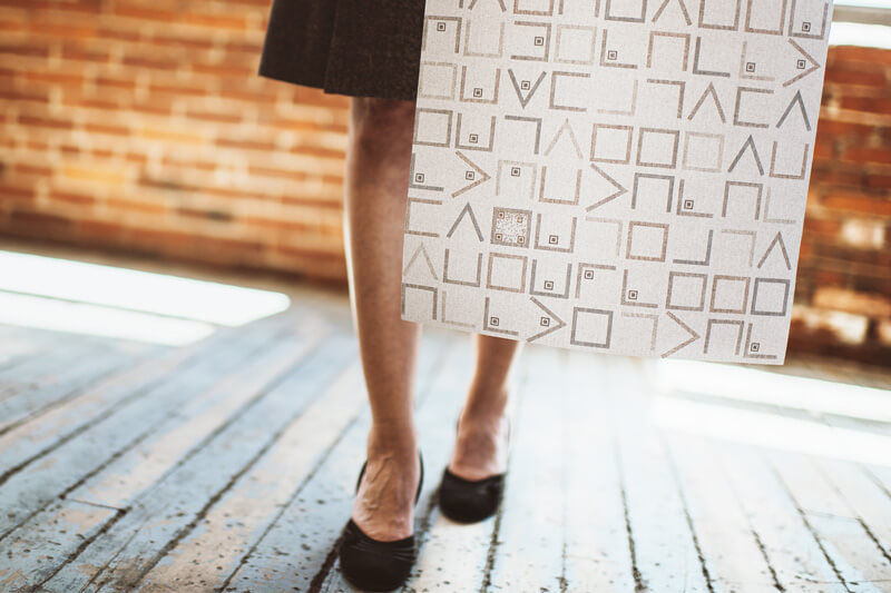 Woman holding large sample pattern square.