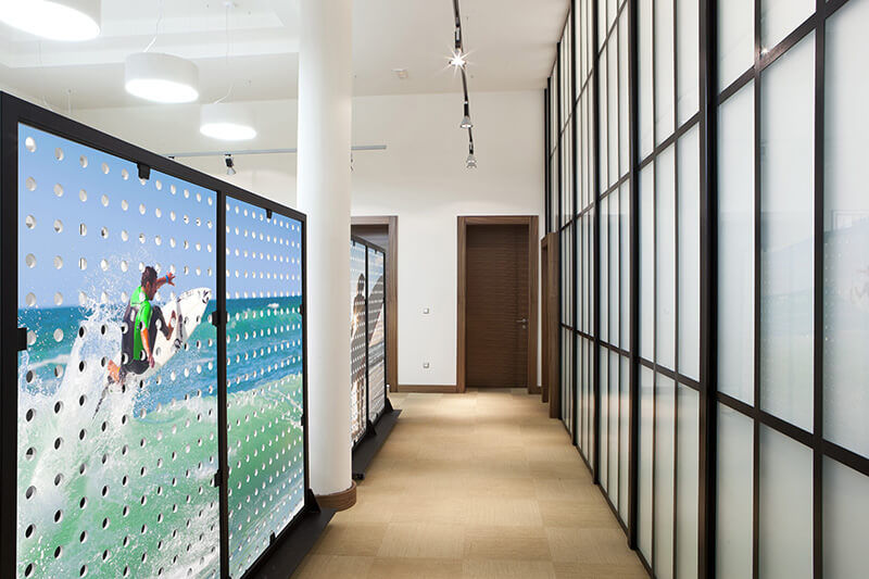 A corridor with wall decor on the left and panels on the right.