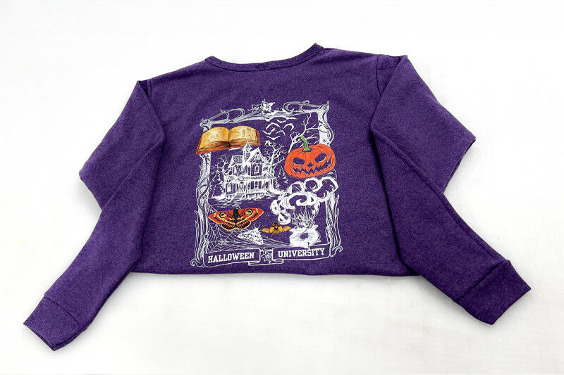 Purple sweater with digitally printed Halloween design.