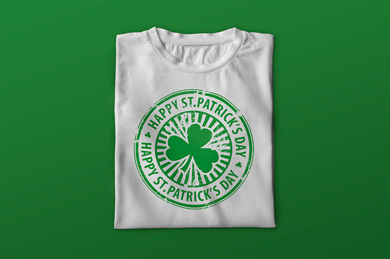 Folded white T-shirt with shamrock and words "Happy St. Patrick's Day"