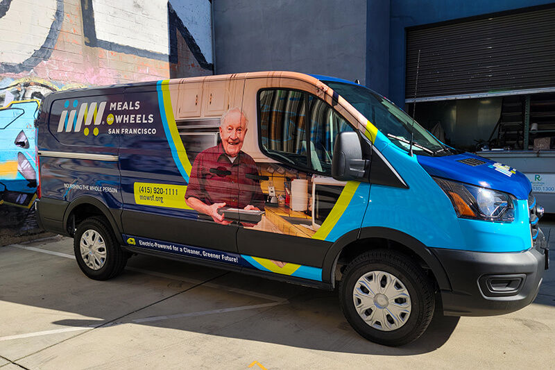 Side view of van wrapped with another set of Meals on Wheels graphics