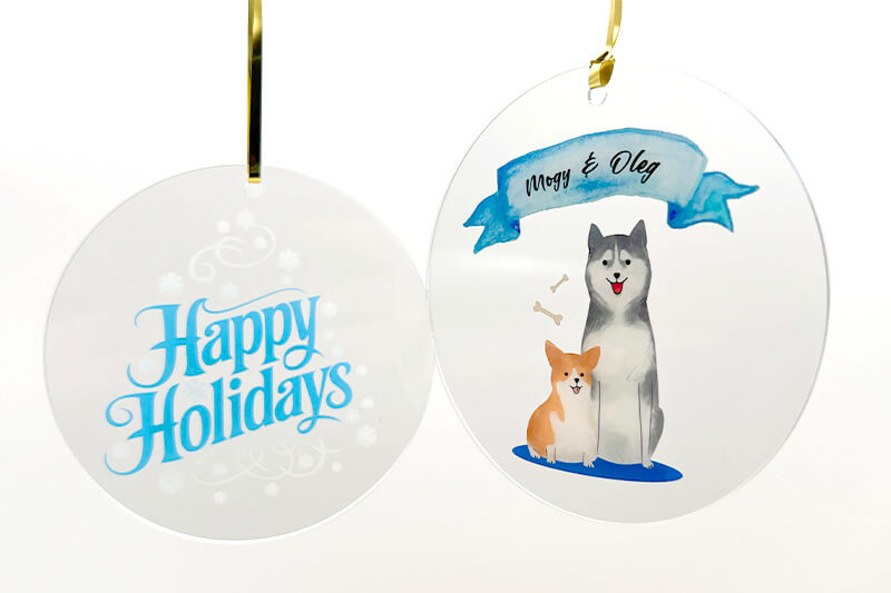 Two acrylic ornaments one saying "happy holidays" and the other with an image of a cat and dog.