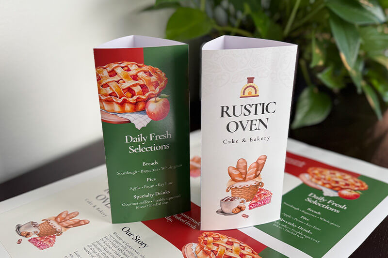 Stand up trifold brochure with pie and bread graphics and "Rustic Oven" text.