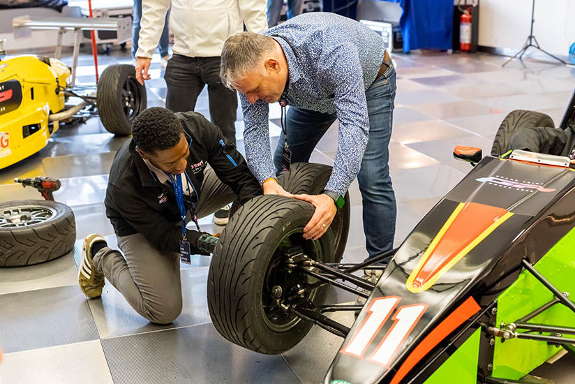 Attendees experiencing an F1 tire change.