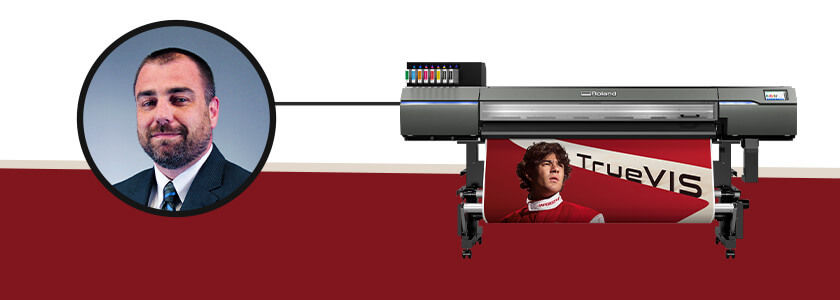 Head shot of Roland DGA Product Manager Daniel Valade next to TrueVIS XP-640 digital printer.