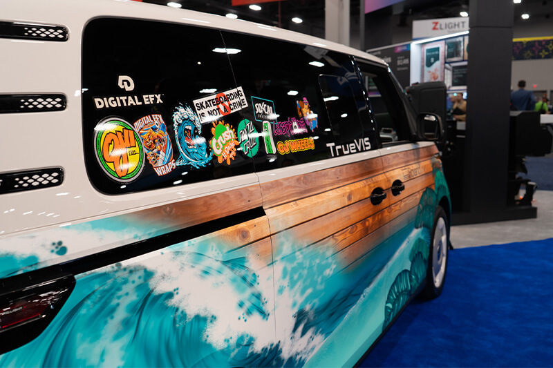 Side panel view of wrapped VW electric bus at Roland DGA booth at ISA.