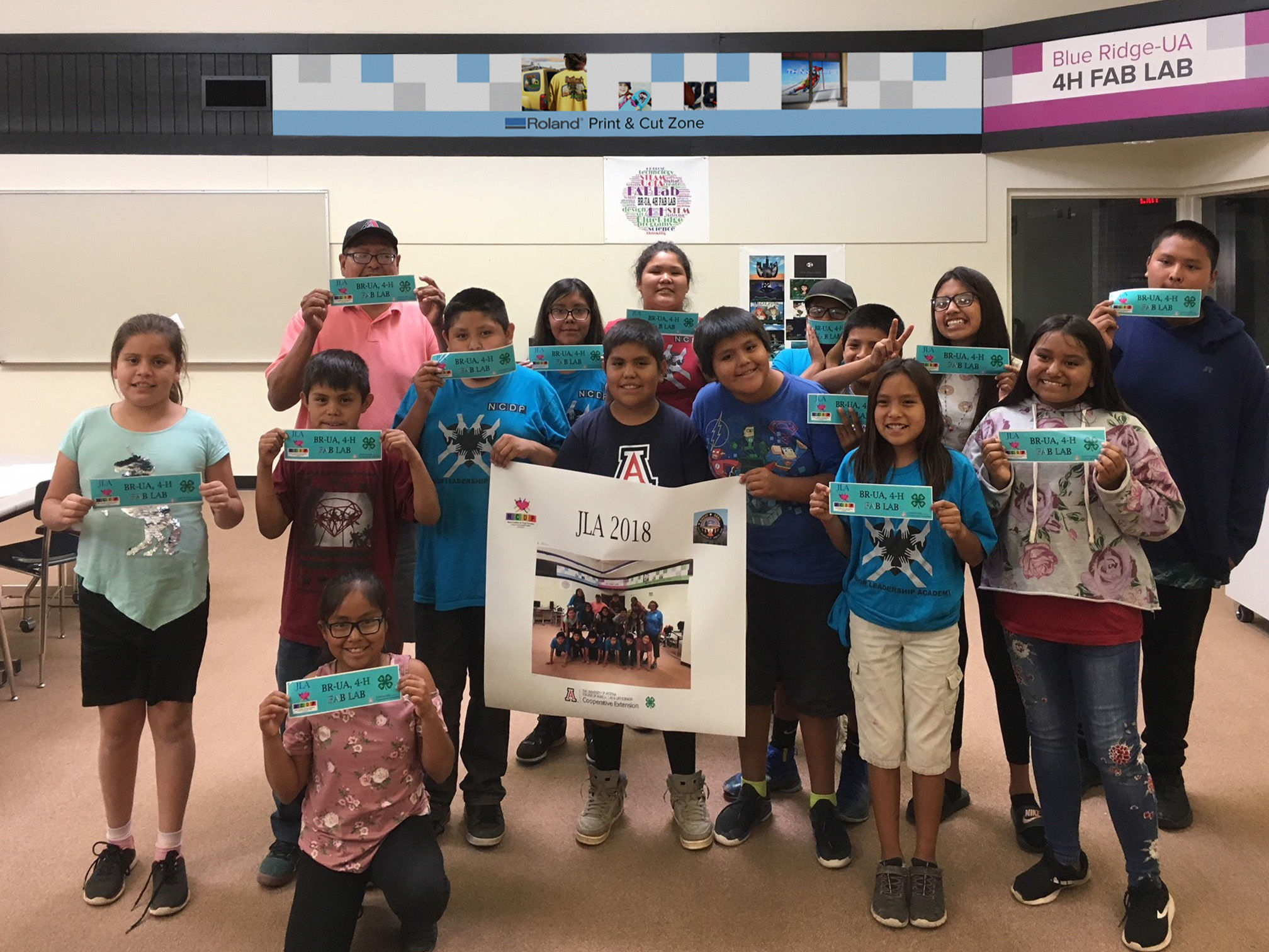Apache Tribe 4-H Junior Leadership Academy students display bumper stickers made using a Roland wide-format printer/cutter.