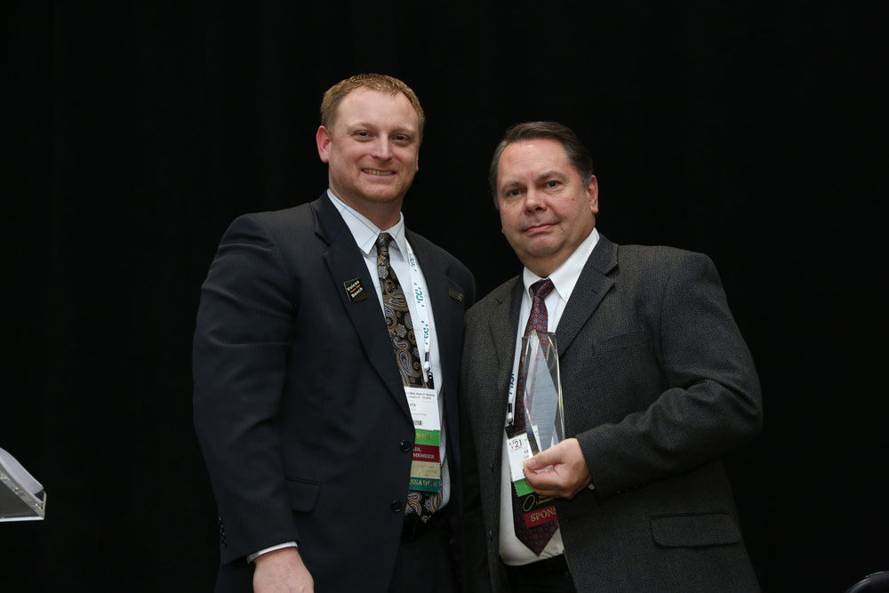 Photo of Roland DGA Manager of Business Development Grant Davis receiving Roland DGA Corporation's NADL 2019 Supplier of the Year Award.