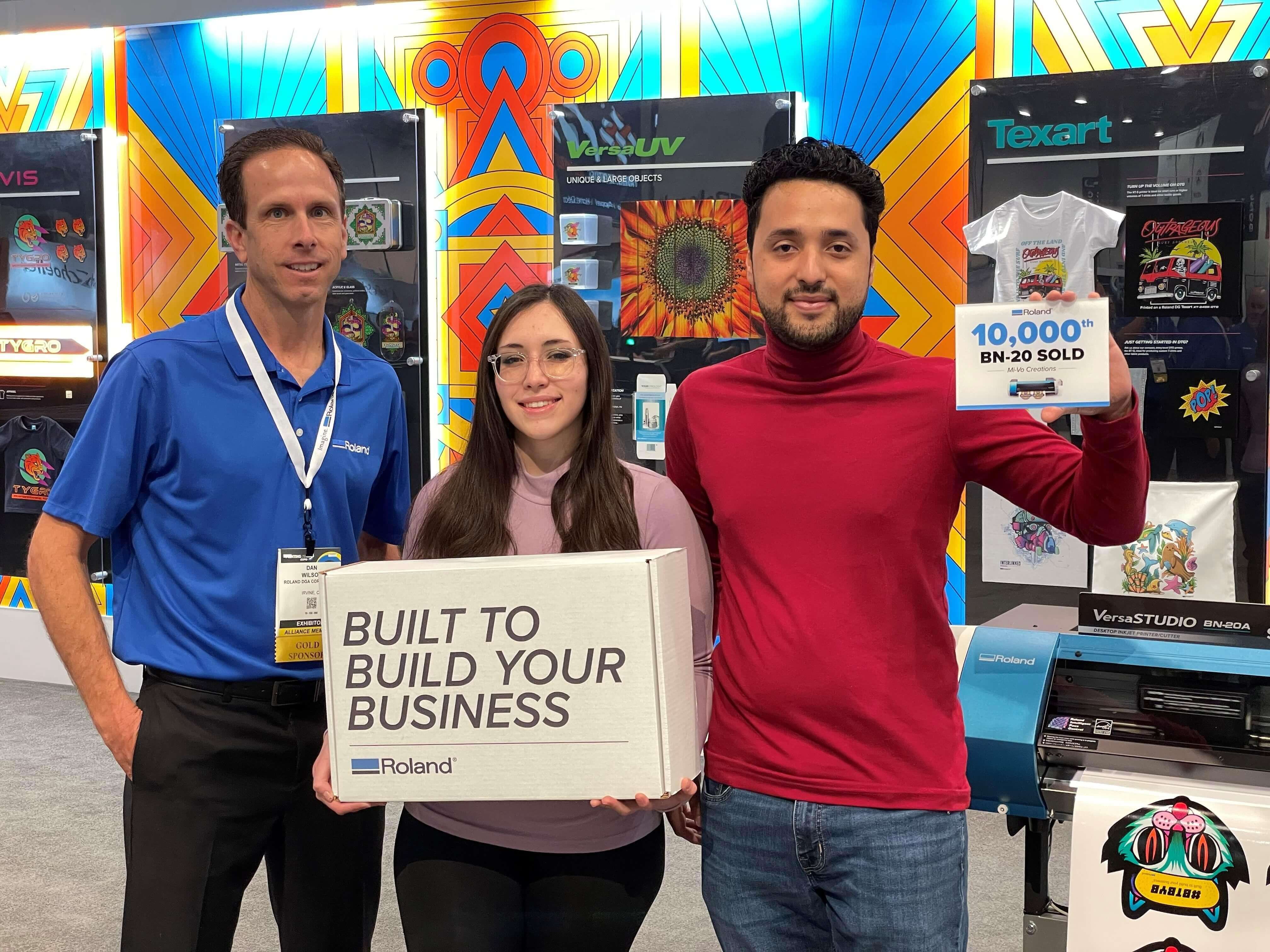 Image of  Roland DGA's in-booth presentation to 10,000th BN-20 buyer at PRINTING United 2022 Expo 