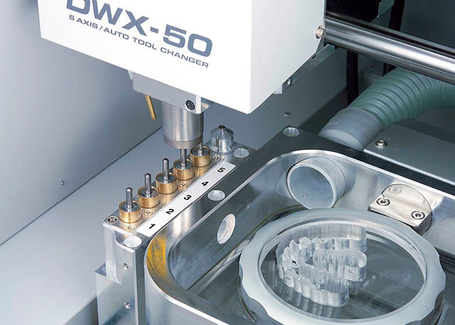 2011 Roland expands its dental mill line with the DWX-50, featuring 5-axis machining capability and an automatic tool changer for production of dental prosthetics.