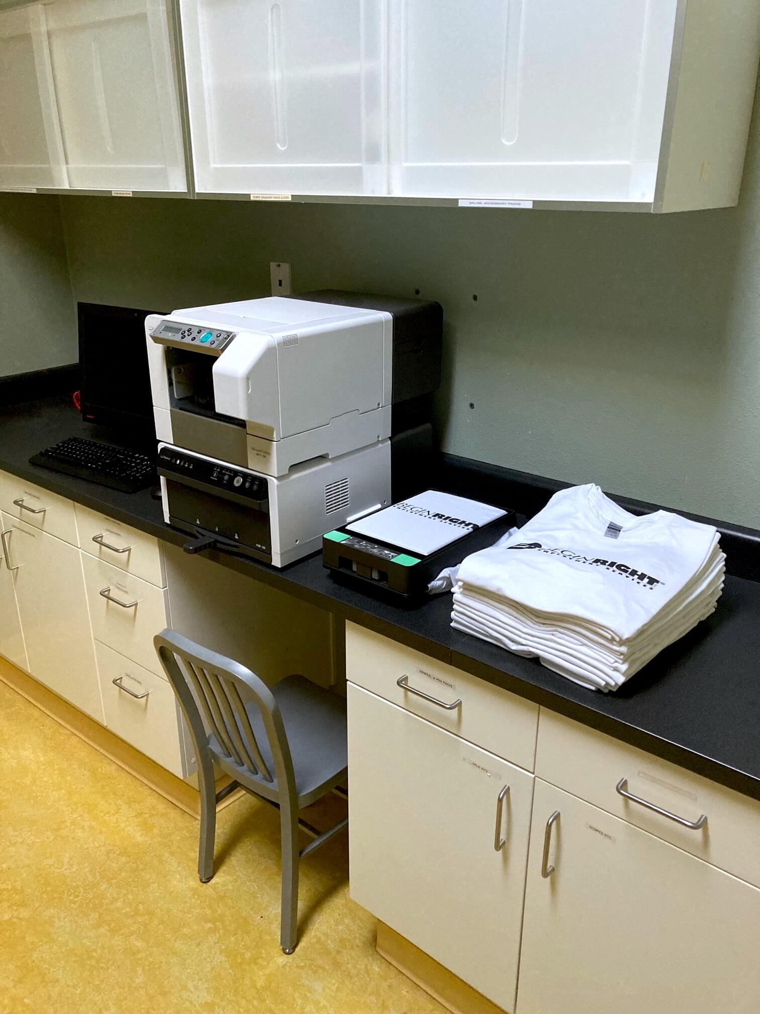 BeginRight Employment Services keeps its Roland DG direct-to-garment printer on a counter next to several of its logo-printed T-shirts.