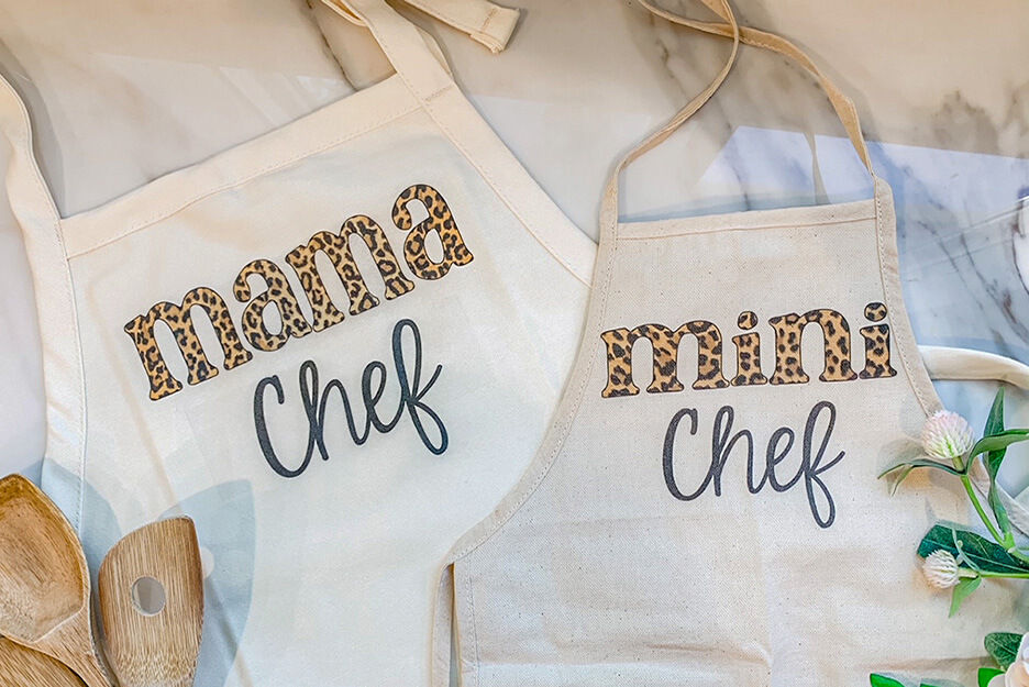 These two aprons are imprinted using a Roland DG BT-12 DTG printer with "Mama Chef" and "Mini Chef" by Etsy seller Wendy and Wander.