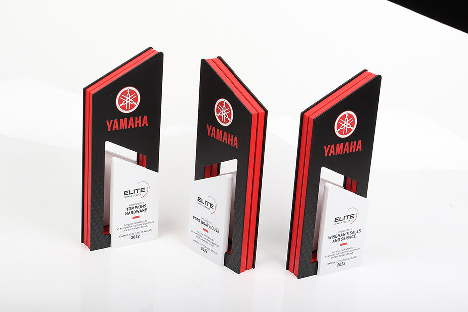 Three corporate awards with black, red and white graphics