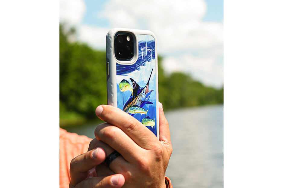 Hand holding a phone case with a blue wave and swordfish design, printed on a Roland DG VersaUV LEF2 printer