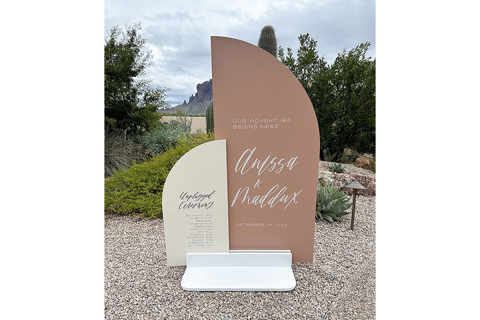 Off white and clay colored standing sign announcing the wedding of Alyssa and Maddox.