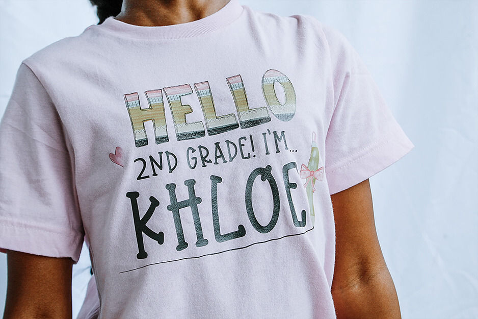 Torso in a T-shirt that says "Hello 2nd Grade I'm Khloe"