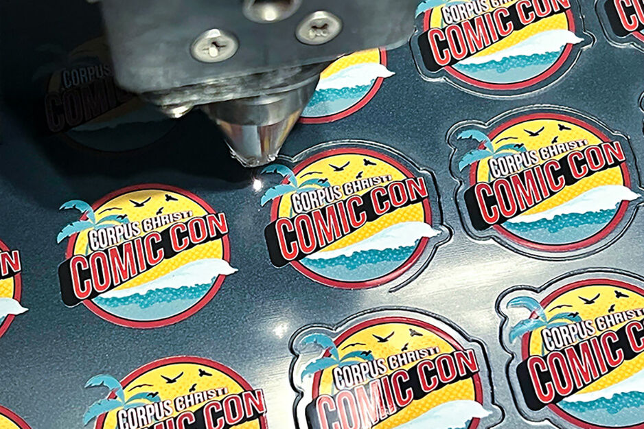 ComicCon pins being created in a machine.