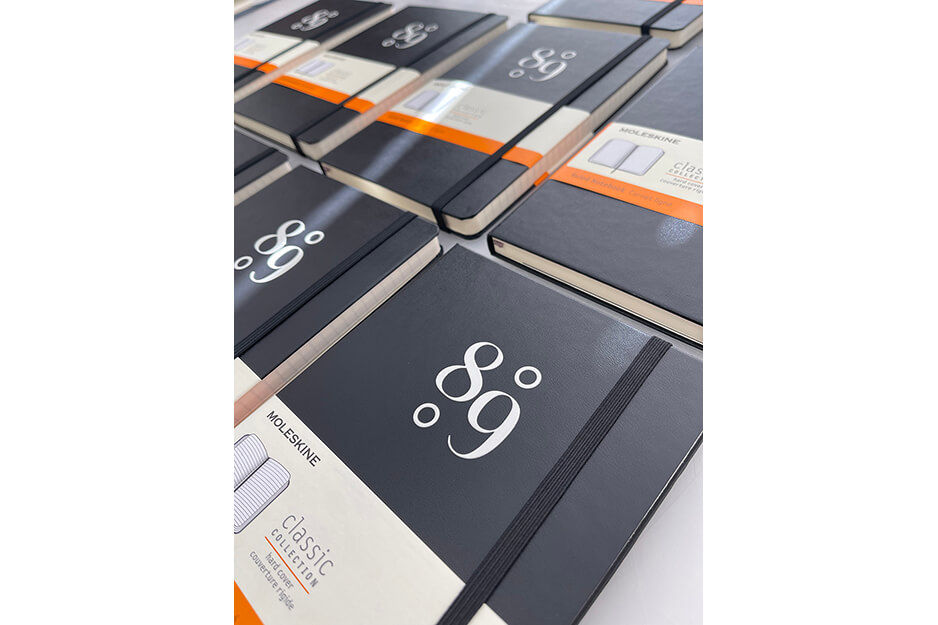 Rows of custom printed Moleskine journals