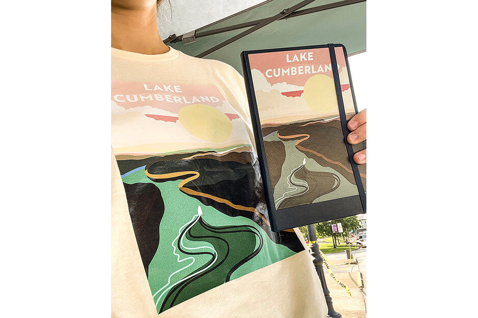 T shirt graphics  worn by a woman holding matching graphics printed on journal