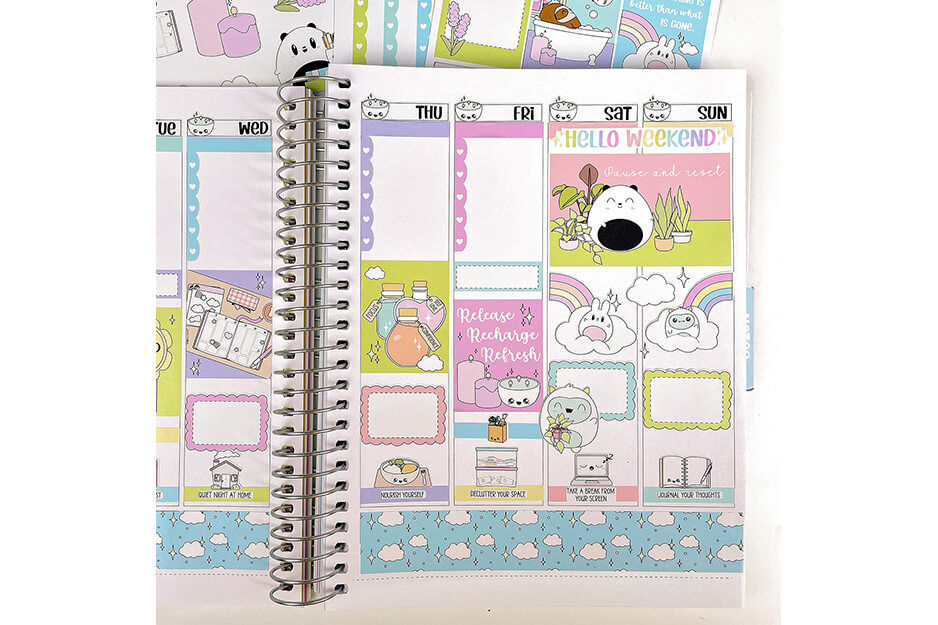 Open spiral-bound planner with multiple pastel stickers produced on a Roland DG TrueVIS VG2 printer/cutter