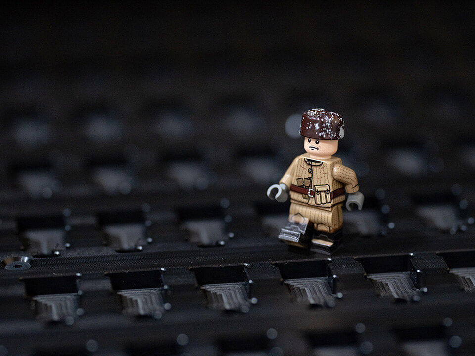 Customized mini figure of a man walking in snow.