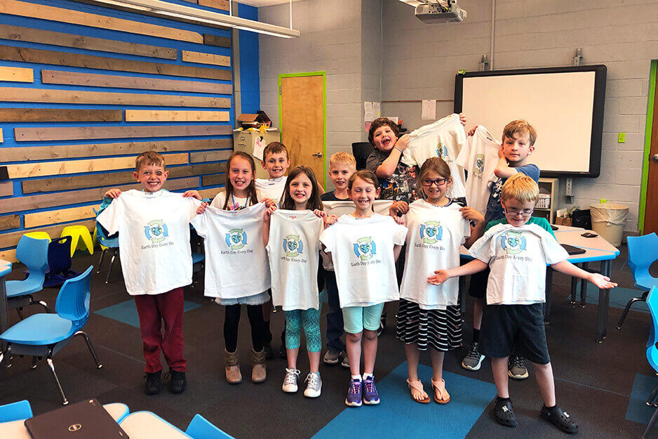 Burrell Elementary students hold the t-shirts they made using the Roland BT-12 direct-to-garment printer