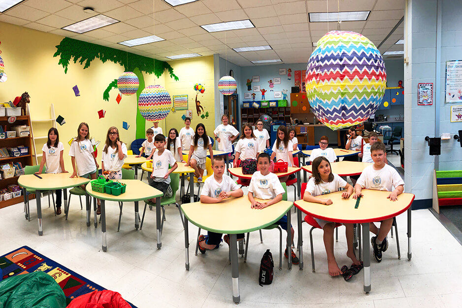 Students at Burrell Elementary proudly wear the t-shirts they helped produce on the Roland BT-12 direct-to-garment printer.