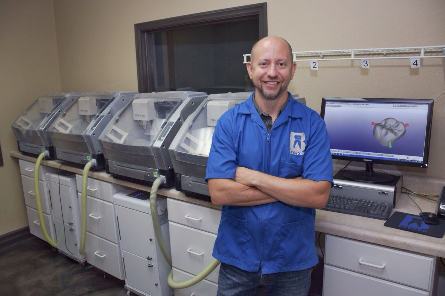 Daniel Becker, C.D.T. with Becker Dental Lab's four Roland DWX-50s