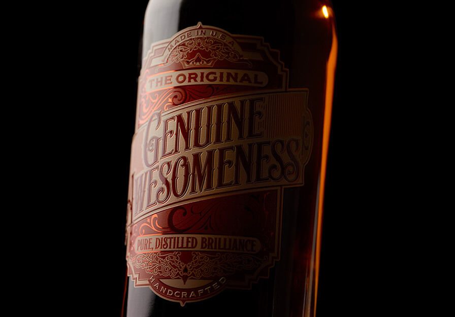 Close up of bottle with dark red label with gold writing saying Genuine Awesome 