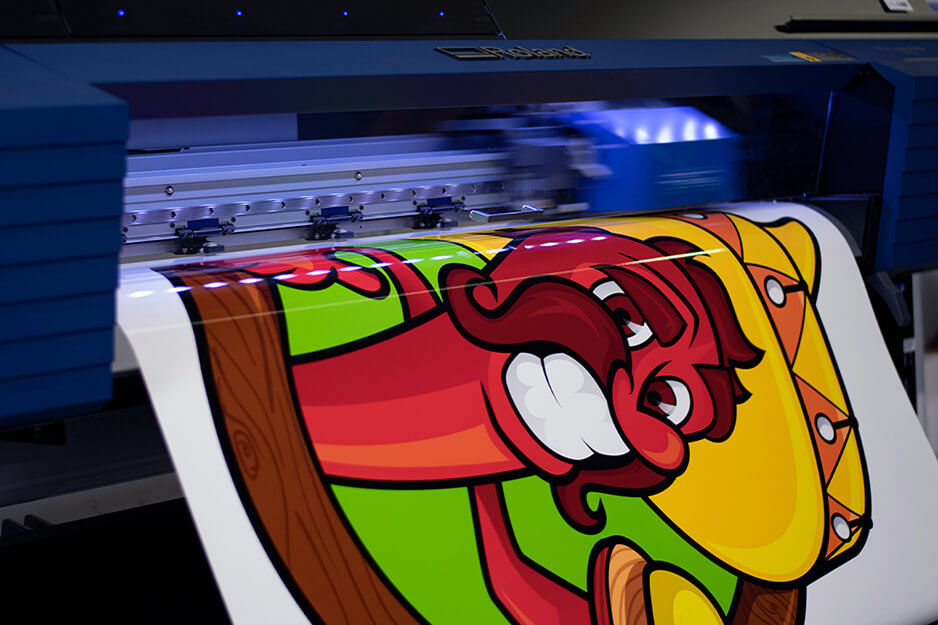 Asheville Color and Imaging's Roland DG TrueVIS VG2-540 digital printer/cutter is hard at work printing colorful vehicle graphics.