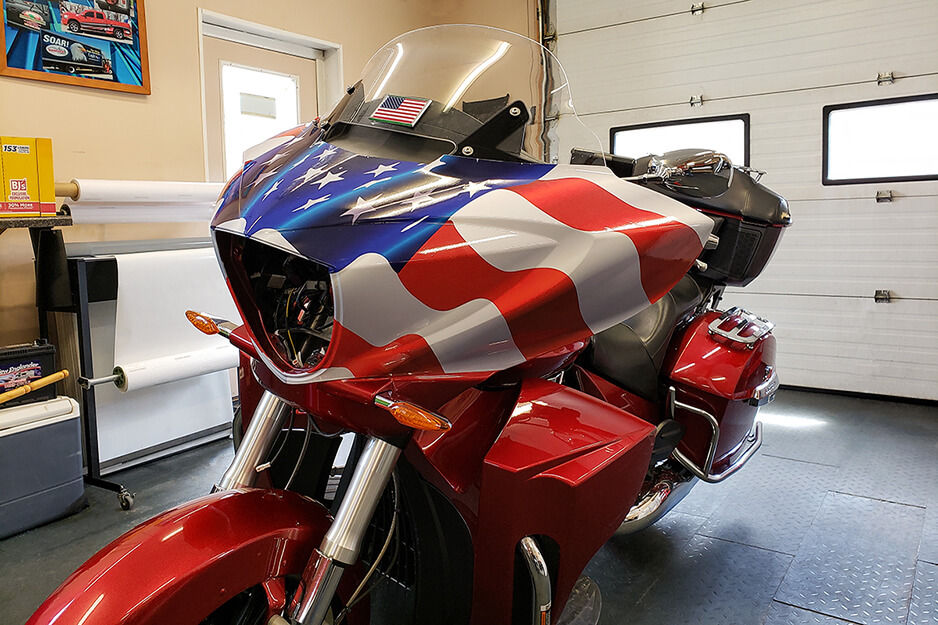 Image shows motorcycle wrapped in patriotic graphics that were printed on a Roland DG TrueVIS VG2 digital printer/cutter.