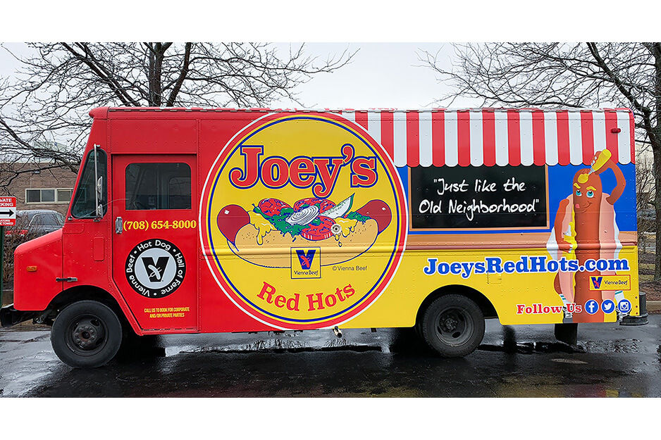 Red food truck with words "Joey's Red Hots" and colorful graphics