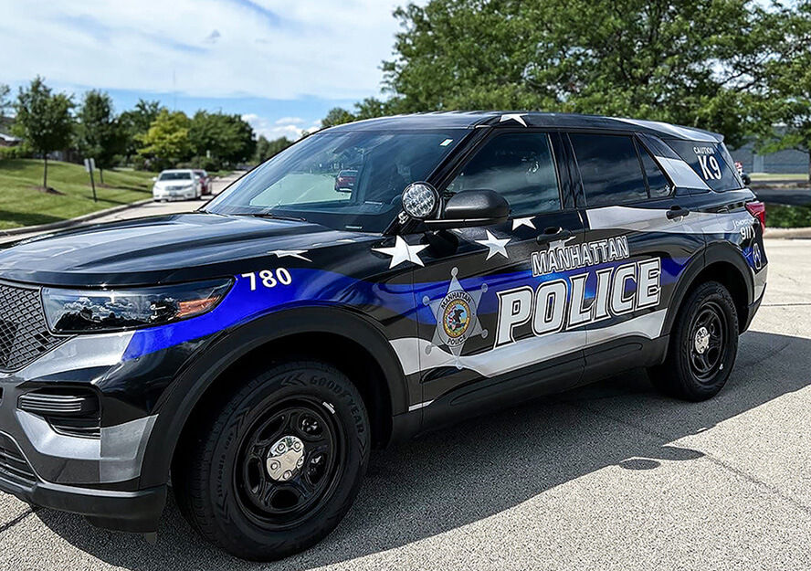 Police SUV with words "Manhattan Police" and graphics on side panel