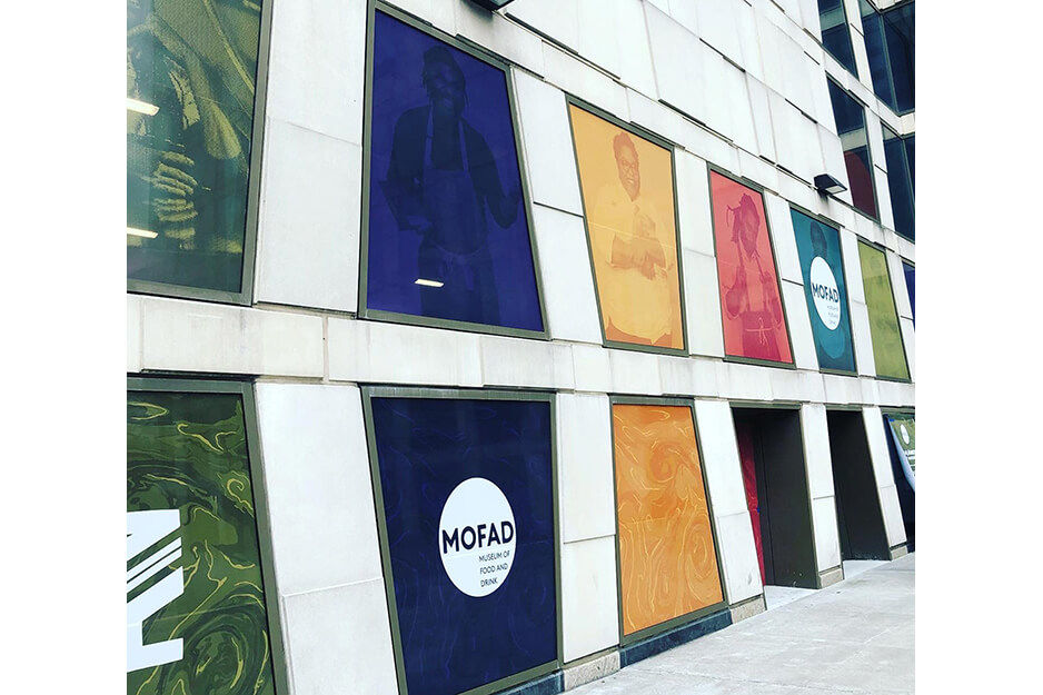 Color-block window graphics cover windows at MOFAD. The graphics were produced on Full Point Graphics' Roland DG TrueVIS VG2 printer/cutter.