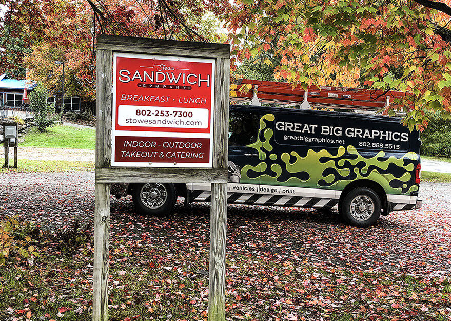 Standing sign with Great Big Graphics' van in the background.