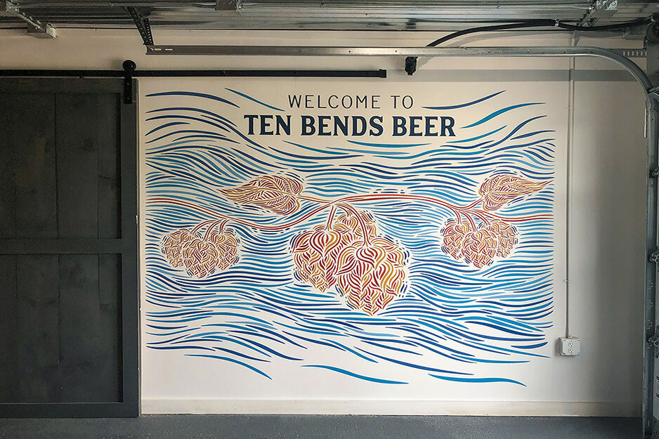 Blue and red wall graphics with words "Ten Bends Beer"