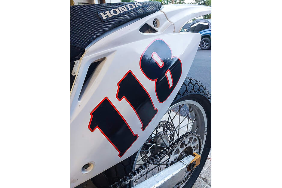 Panel de guardabarros de una motocicleta con números “118”